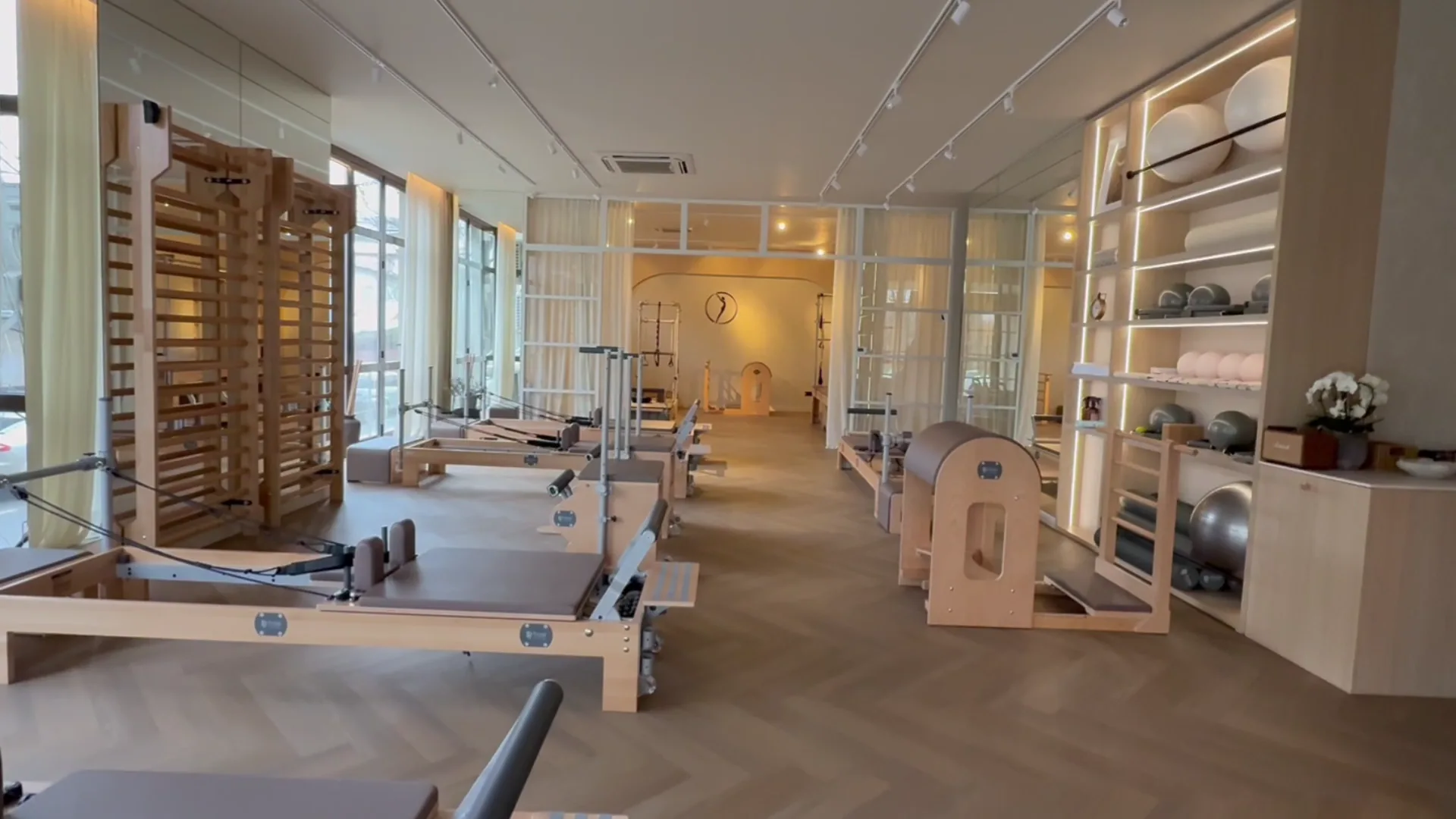 Studio de pilates cu aparate Reformers din lemn și lumină naturală